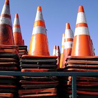 A large stack of orange safety traffic cones