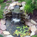 A small pond with soothing sounds of a waterfall