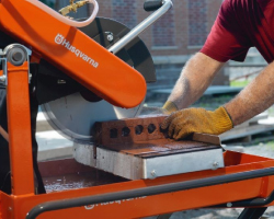 Cutting bricks using a diamond saw.