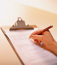 A woman's hand filling out an application form.