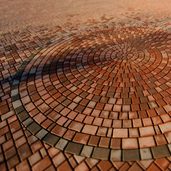 A circular pattern of red paving stones.