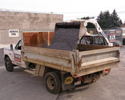 Dave loading our 3-yard delivery truck with decorative stone.
